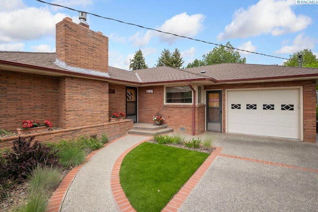 407 Steptoe St, Colton, WA 99113 - view of front of property featuring a garage, a chimney, driveway, brick siding, and roof with shingles