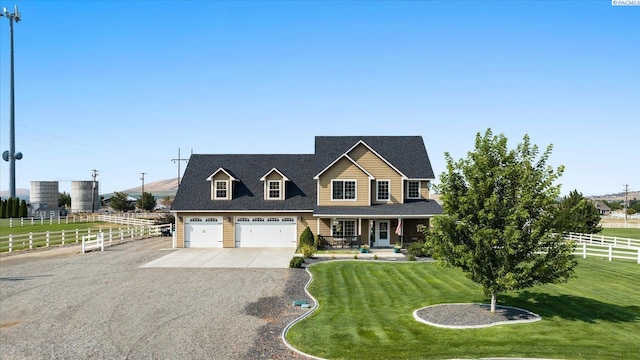 view of front of property with a garage, a porch, and a front lawn