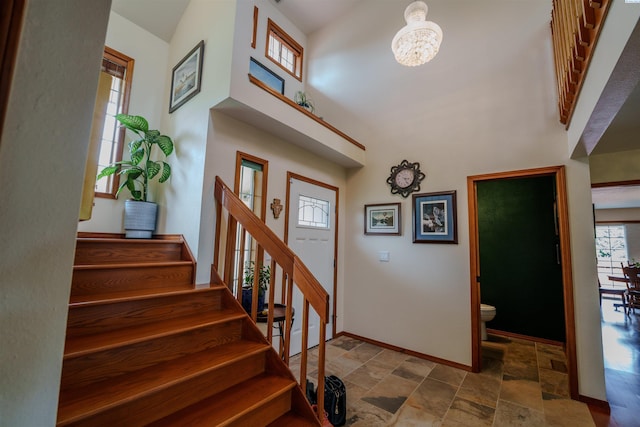 2929 S Ledbetter Pl, Kennewick, WA 99337 - staircase featuring stone finish floors, a towering ceiling, and a chandelier