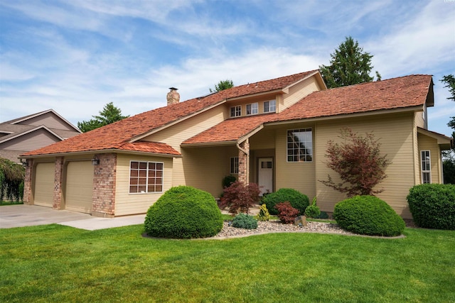 2929 S Ledbetter Pl, Kennewick, WA 99337 - view of front of home with a chimney, an attached garage, a front lawn, and driveway