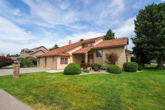 2929 S Ledbetter Pl, Kennewick, WA 99337 - view of front of property featuring concrete driveway, an attached garage, a chimney, and a front yard