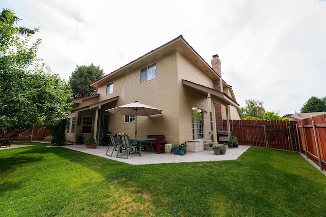2929 S Ledbetter Pl, Kennewick, WA 99337 - rear view of house with a patio, a fenced backyard, and a chimney