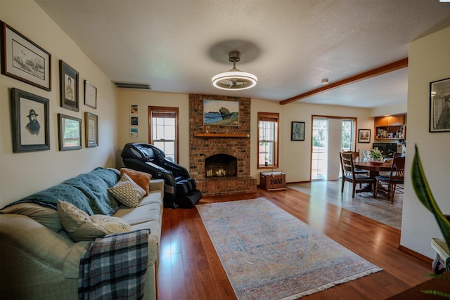 2929 S Ledbetter Pl, Kennewick, WA 99337 - living area featuring wood finished floors, a brick fireplace, and beamed ceiling