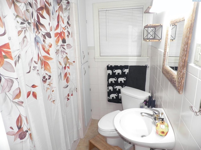 bathroom featuring sink, tile walls, tile patterned flooring, toilet, and walk in shower