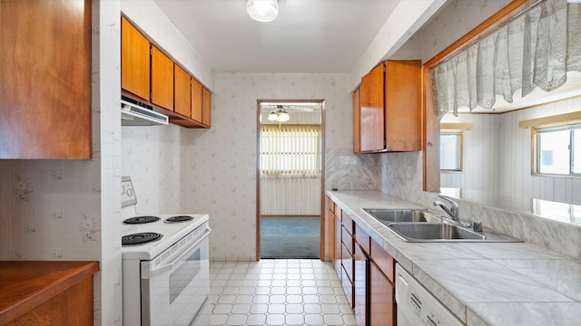 2111 W 20th Ave, Kennewick, WA 99337 - kitchen with white appliances, exhaust hood, brown cabinets, ceiling fan, and wallpapered walls