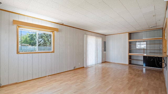 2111 W 20th Ave, Kennewick, WA 99337 - spare room featuring wood finished floors, electric panel, crown molding, and wood walls