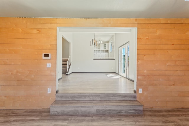 1621 S Fruitland St, Kennewick, WA 99337 - hallway featuring wood walls, stairs, wood finished floors, and a chandelier