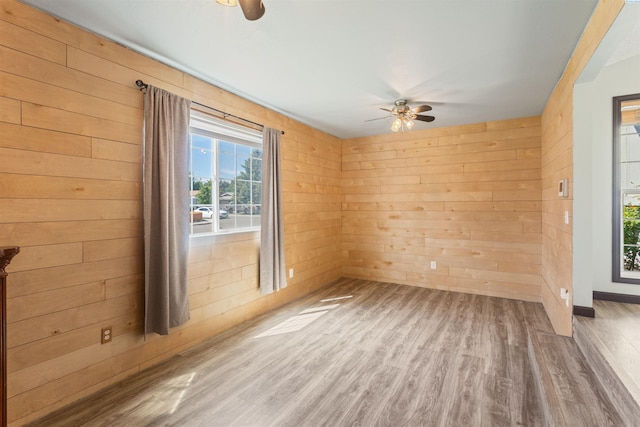1621 S Fruitland St, Kennewick, WA 99337 - unfurnished room with a ceiling fan, wooden walls, and wood finished floors