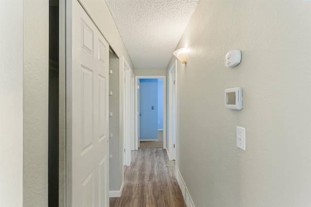 1621 S Fruitland St, Kennewick, WA 99337 - hall with dark wood-style floors, a textured ceiling, and a textured wall
