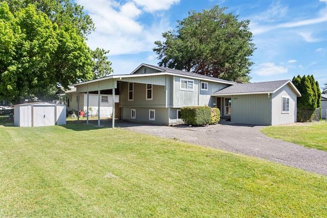 1621 S Fruitland St, Kennewick, WA 99337 - split level home with gravel driveway, a storage unit, a front lawn, and an attached carport