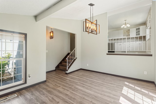 1621 S Fruitland St, Kennewick, WA 99337 - unfurnished room featuring a chandelier, wood finished floors, and stairway