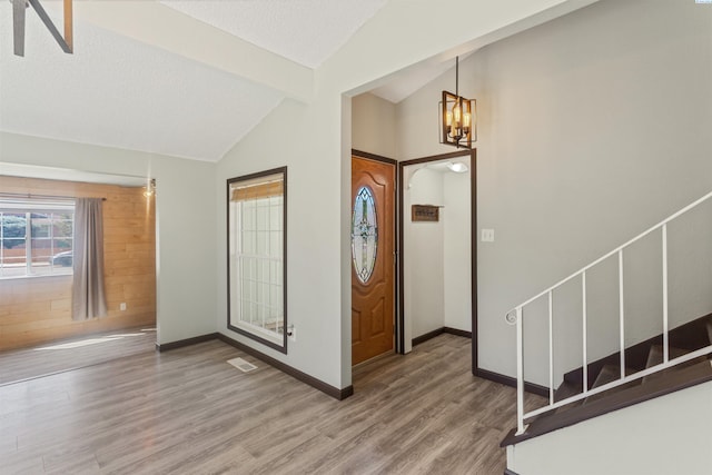 1621 S Fruitland St, Kennewick, WA 99337 - foyer entrance with vaulted ceiling, wood finished floors, a chandelier, and stairway