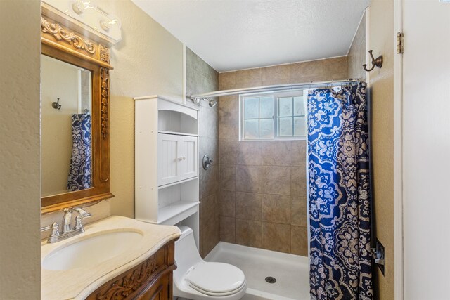 1621 S Fruitland St, Kennewick, WA 99337 - bathroom featuring vanity, a tile shower, and a textured wall