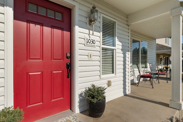 view of exterior entry featuring a porch