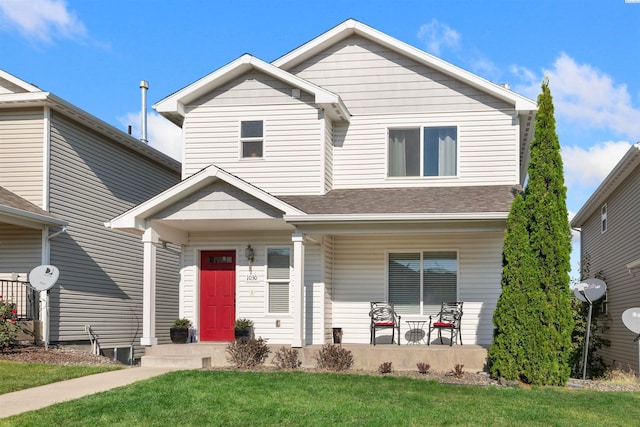 view of property featuring a porch and a front yard