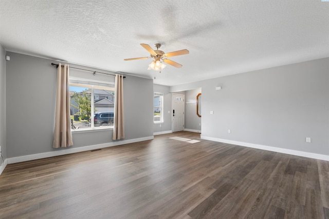 spare room featuring a textured ceiling, ceiling fan, and dark hardwood / wood-style floors