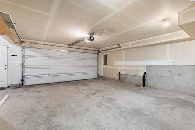 garage featuring a garage door opener and electric panel