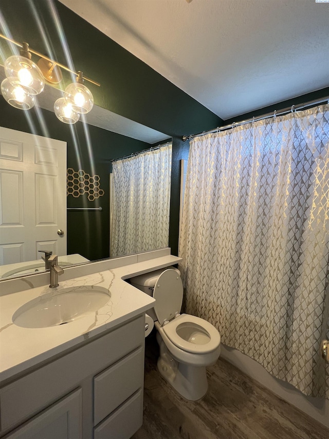 full bathroom featuring toilet, vanity, shower / bathtub combination with curtain, and wood finished floors