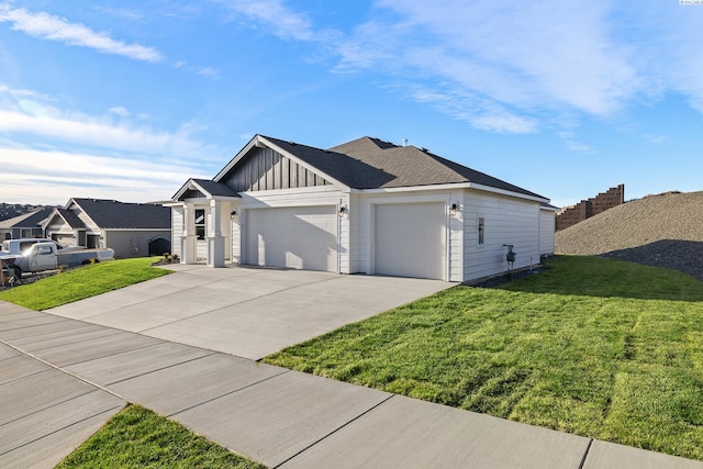 view of front of property featuring an attached garage, driveway, board and batten siding, and a front yard