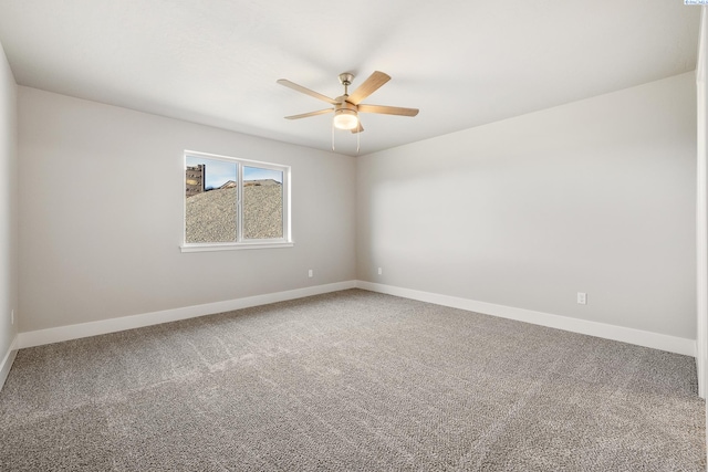 empty room featuring carpet flooring, a ceiling fan, and baseboards