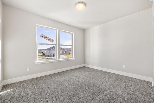 carpeted spare room with baseboards