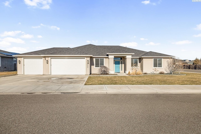 view of front of home with an attached garage, a shingled roof, concrete driveway, stucco siding, and a front yard