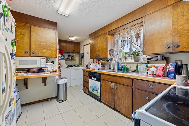 5820 W Park Pl, Pasco, WA 99301 - kitchen featuring washer and clothes dryer, white appliances, a textured ceiling, light countertops, and brown cabinets