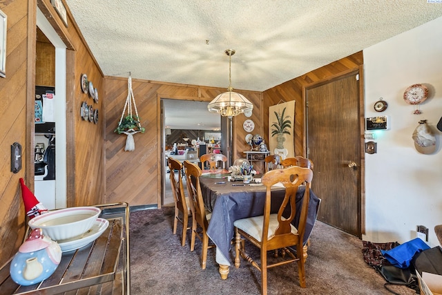 5820 W Park Pl, Pasco, WA 99301 - carpeted dining space featuring wood walls, a chandelier, and a textured ceiling