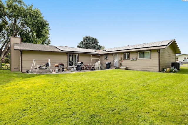 5820 W Park Pl, Pasco, WA 99301 - back of property featuring a yard, a chimney, roof mounted solar panels, and a patio