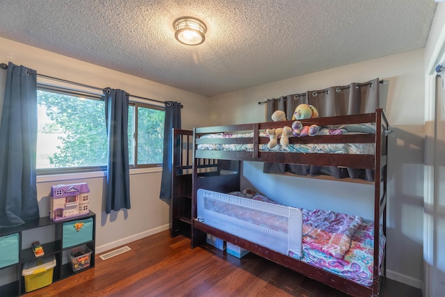 625 SW Dawnview Ct, Pullman, WA 99163 - bedroom featuring wood finished floors, a textured ceiling, and baseboards