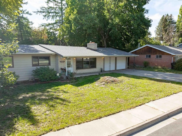 625 SW Dawnview Ct, Pullman, WA 99163 - single story home with a garage, driveway, a chimney, a front yard, and brick siding