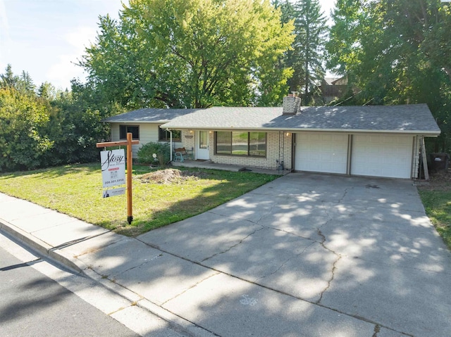 625 SW Dawnview Ct, Pullman, WA 99163 - ranch-style home with an attached garage, a front yard, concrete driveway, a chimney, and brick siding