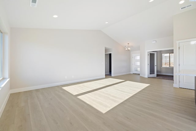 6435 W 30th Pl, Kennewick, WA 99338 - unfurnished living room with lofted ceiling, a chandelier, and light wood-style floors