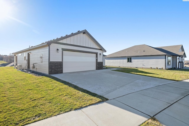 6435 W 30th Pl, Kennewick, WA 99338 - view of side of home featuring board and batten siding, stone siding, and a lawn