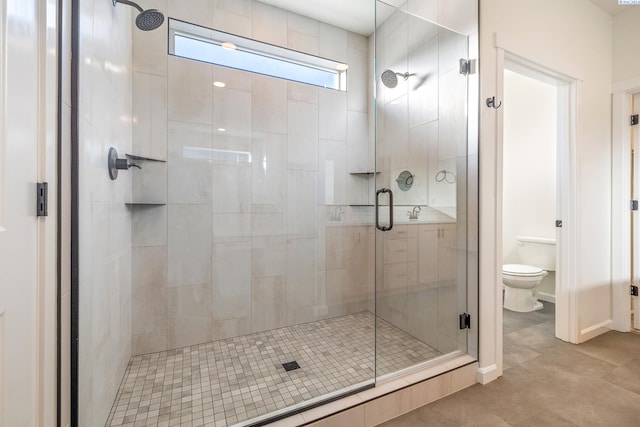 bathroom with an enclosed shower and toilet