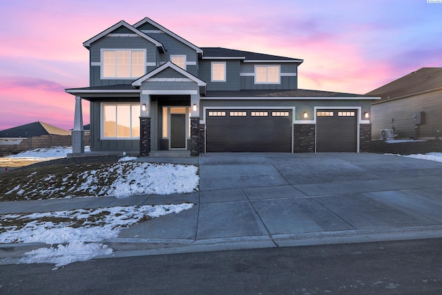 view of front facade with board and batten siding, driveway, and an attached garage