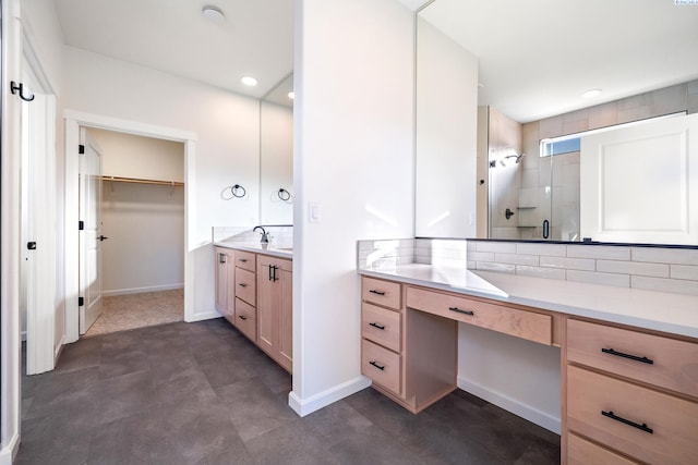 bathroom featuring tasteful backsplash, vanity, and a shower with shower door