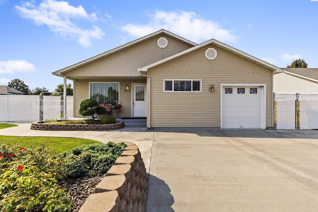 ranch-style home featuring an attached garage, a gate, fence, and concrete driveway