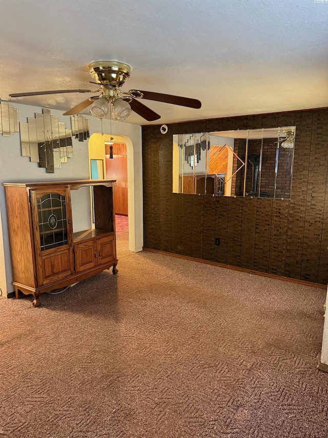 unfurnished living room with ceiling fan