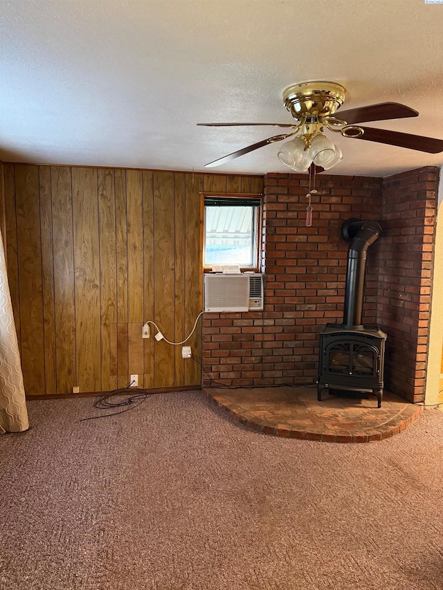 unfurnished living room featuring a textured ceiling, carpet, and a wood stove