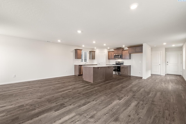 704 S Zeelar St, Kennewick, WA 99336 - kitchen featuring appliances with stainless steel finishes, a center island, open floor plan, dark wood-type flooring, and light countertops