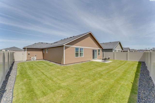 rear view of house featuring a yard and a patio