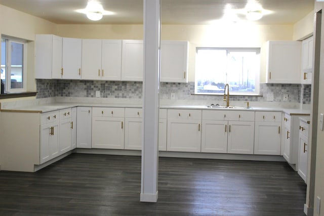 kitchen with white cabinetry, sink, and tasteful backsplash