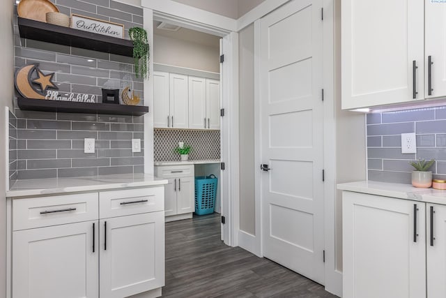 kitchen with dark wood-type flooring, open shelves, white cabinets, and tasteful backsplash