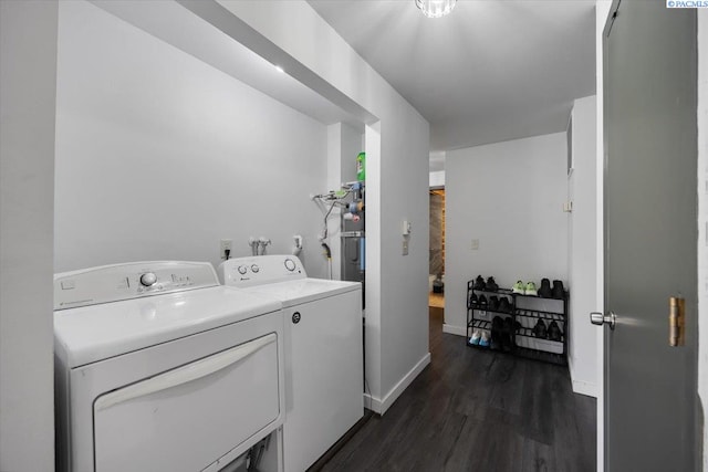 washroom featuring baseboards, laundry area, dark wood-style flooring, and washer and clothes dryer