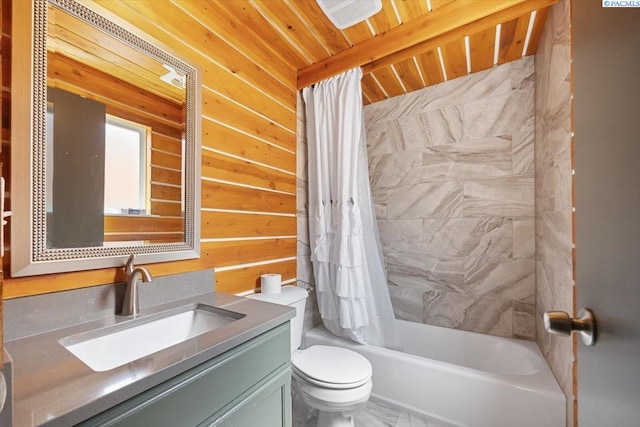 full bathroom featuring vanity, toilet, and shower / bath combination with curtain