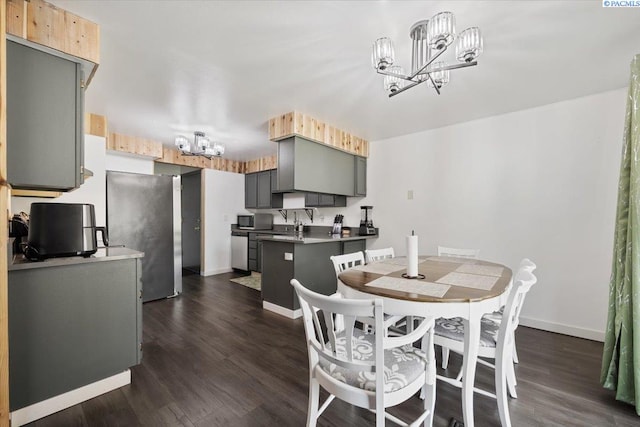 dining area with baseboards, dark wood finished floors, and a notable chandelier