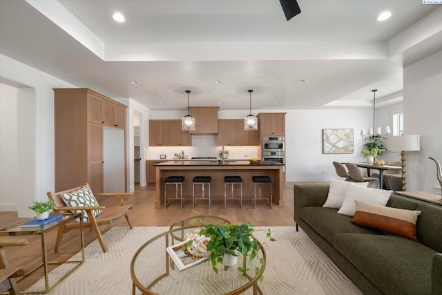 670 Cortona Unit 39, Richland, WA 99352 - living area with a raised ceiling, recessed lighting, baseboards, and light wood-style flooring