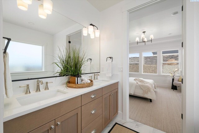 670 Cortona Unit 39, Richland, WA 99352 - bathroom featuring a chandelier, double vanity, and marble look tiles