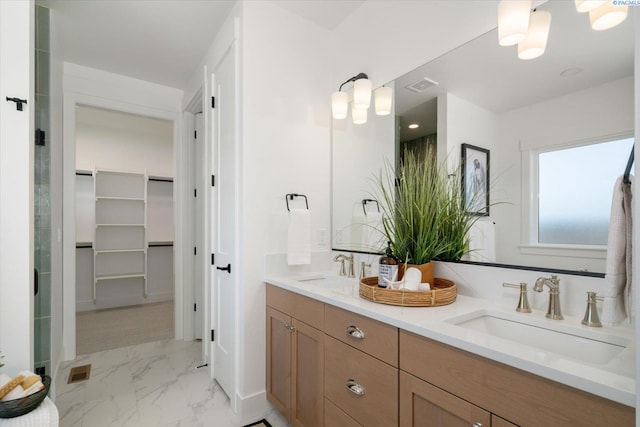 670 Cortona Unit 39, Richland, WA 99352 - bathroom with double vanity, marble look tiles, and a spacious closet